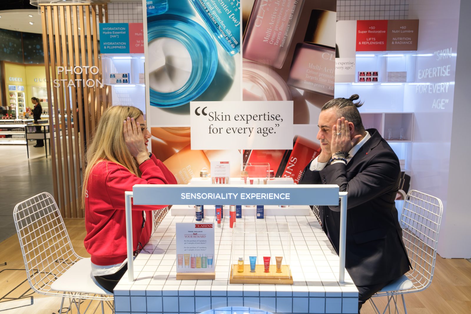 Two guests at the Clarins sensoriality experience table during a brand activation at Istanbul Airport.