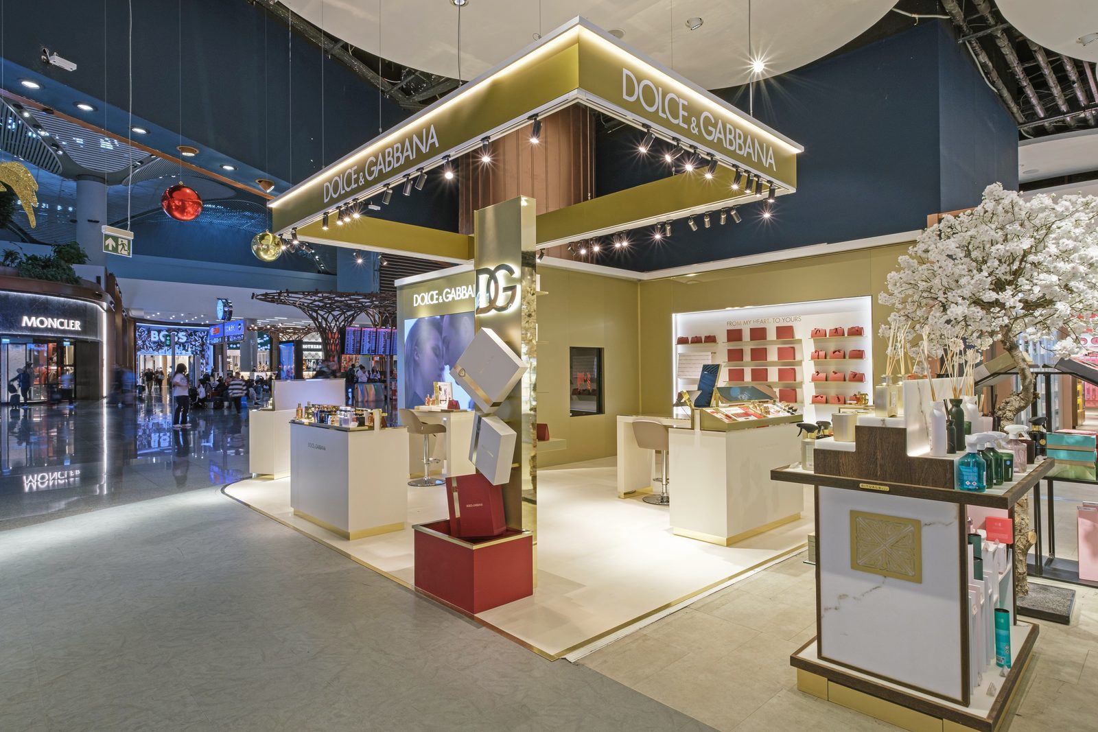Dolce & Gabbana beauty boutique under its gold canopy in the Istanbul Airport duty free hall.