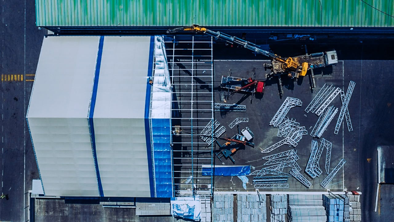 Aerial view of a factory under construction, steel framework and cranes assembling the building, Istanbul.