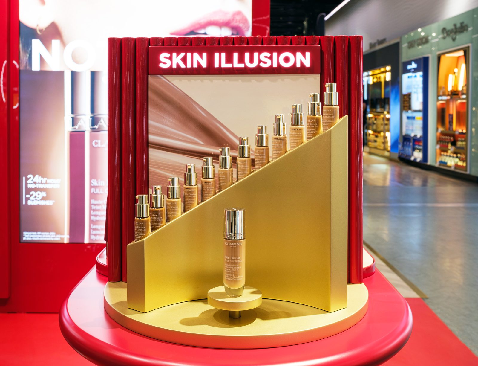 Clarins Skin Illusion foundation range arranged on a gold stepped display.