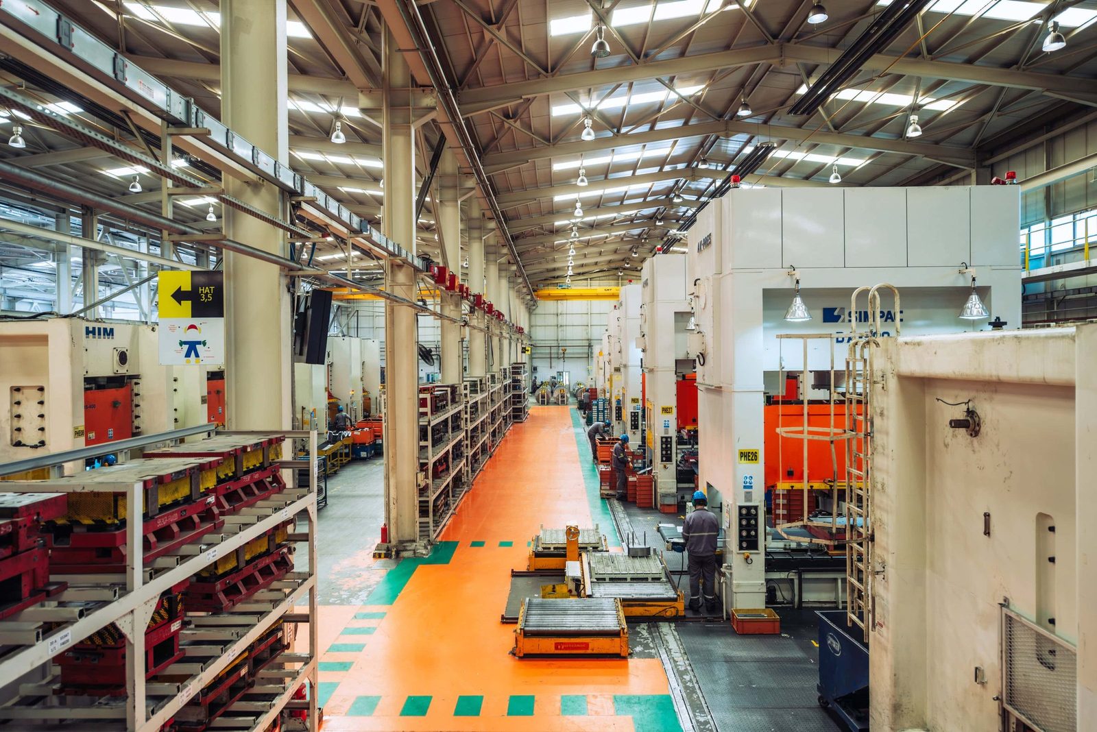 Production line overview inside a large manufacturing plant, high ceilings and ordered machinery, Istanbul.