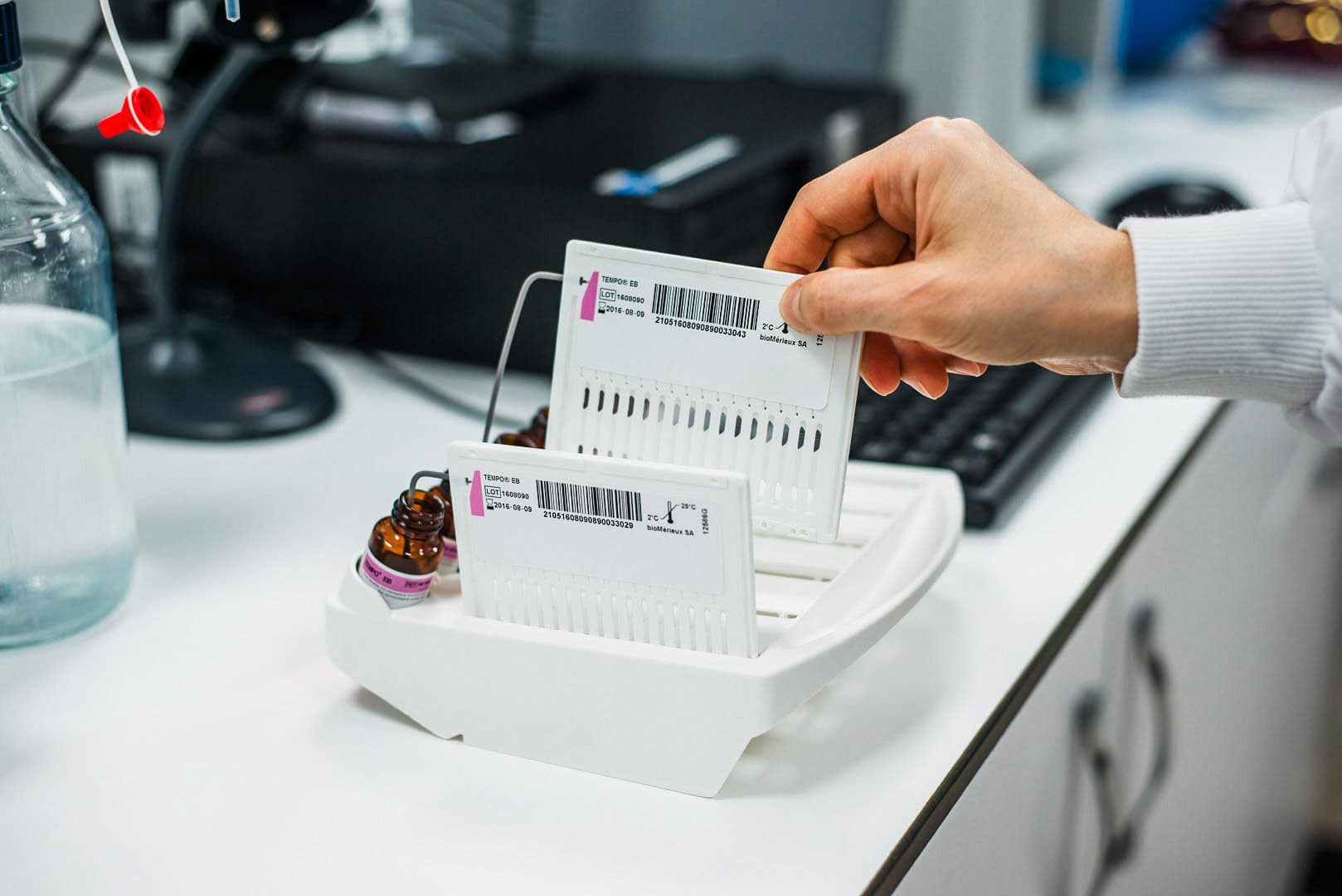 Barcode labels on medicine vials in a laboratory setting.