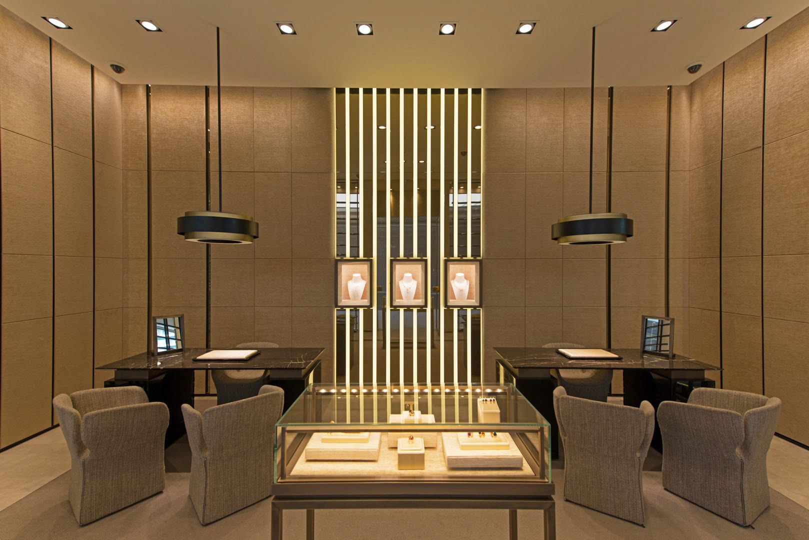 Expositor de joyería contemporánea en el interior de una tienda de lujo, con iluminación cuidada y elementos de diseño de líneas limpias.