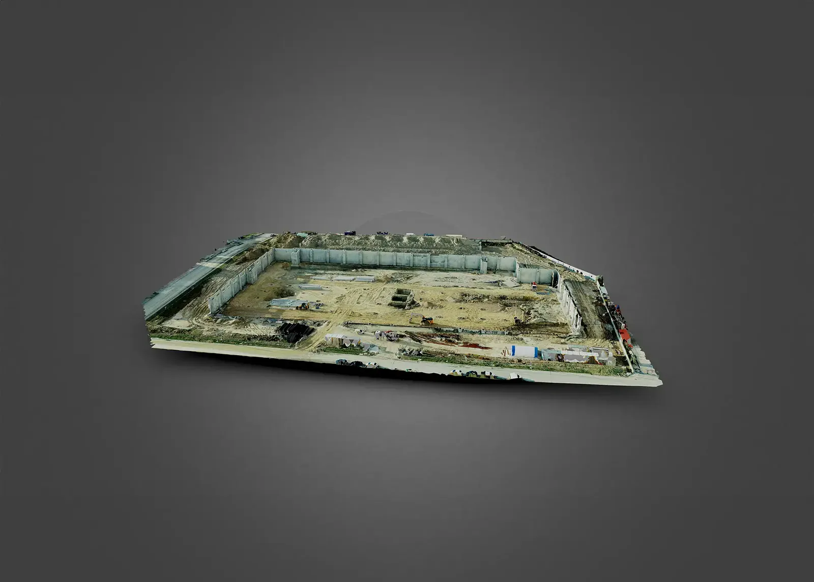 Photogrammetry model of a construction site enclosed by retaining walls, with excavated ground and site plant.