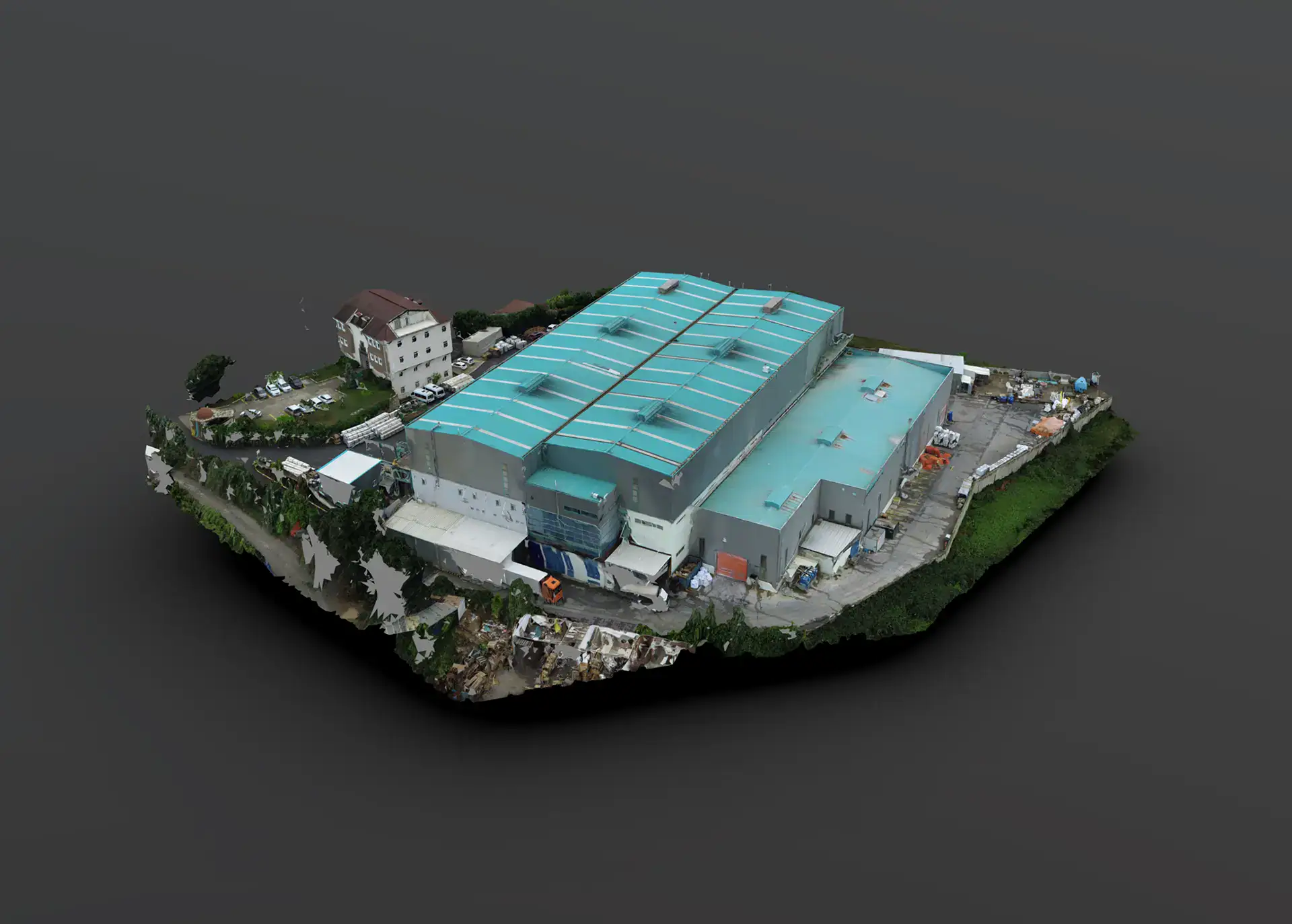 Photogrammetry model of a factory with teal roof panels and its surrounding yard.