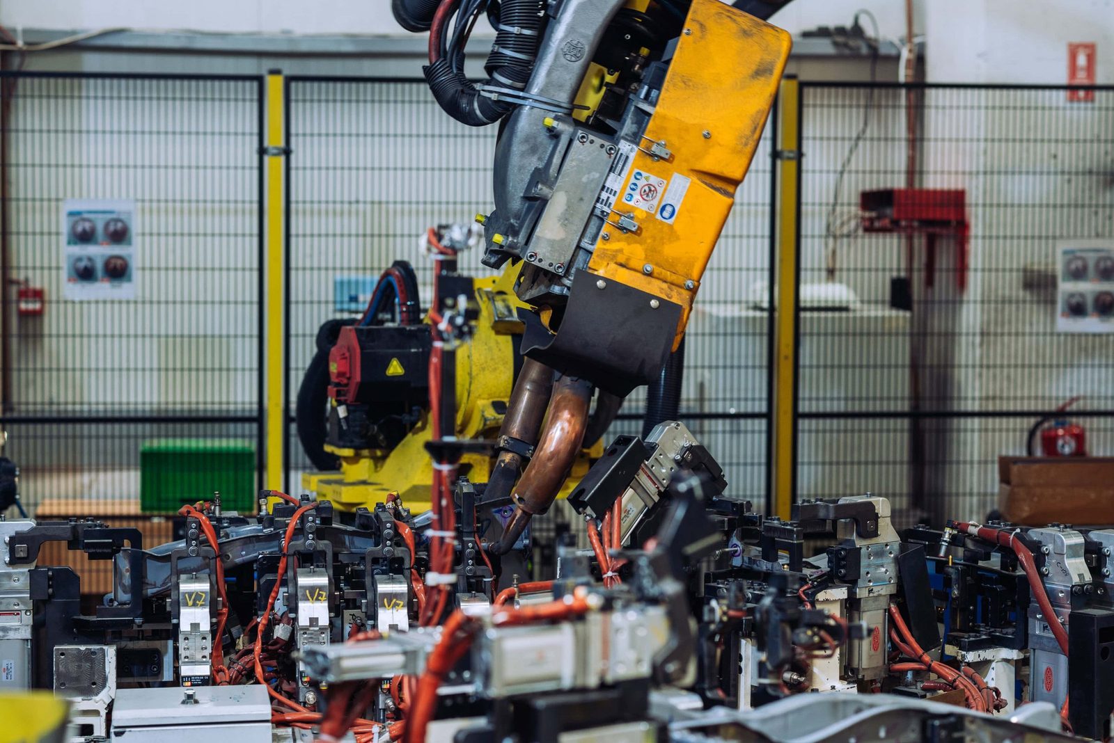 Automatic industrial robot arm working on assembly line in factory; detailed machinery for manufacturing processes.