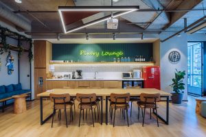 Modern interior of a cozy café with wooden furniture, neon sign reading "Luxury Lounge," and contemporary decor in a vibrant and inviting atmosphere.