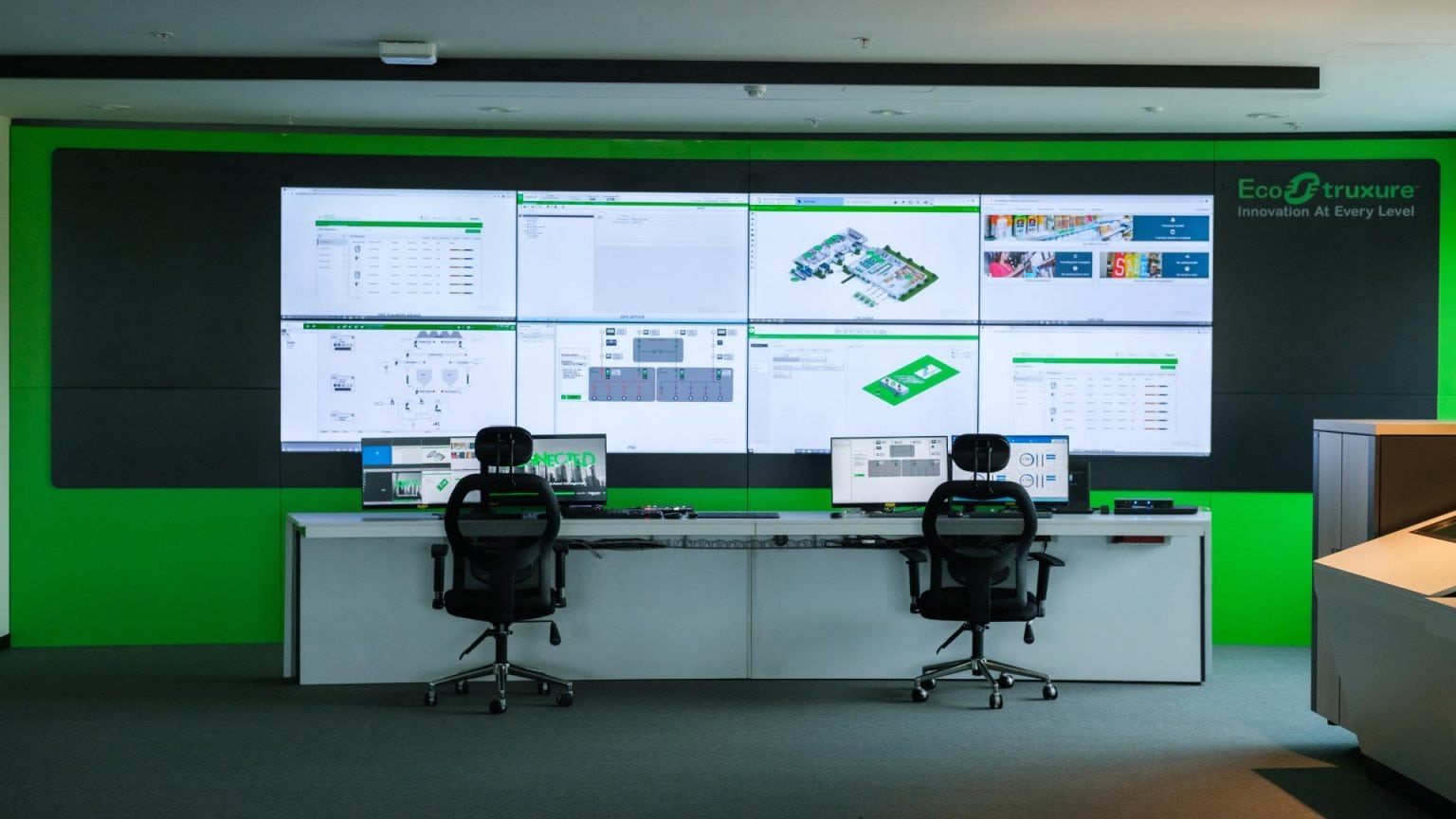 Control Room with Multiple Monitors for Airport Operations Schneider Electric EcoStruxure control room with video wall display. Technology showroom photography by TKM Photo.